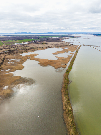 Aerial view of Lake Atanasovsko featuring salt pans and extensive reed beds under a cloudy sky in Burgas Burgas Bulgaria. Aerial view of Lake Atanasovsko featuring salt pans and extensive reed beds under a cloudy sky in Burgas Burgas Bulgaria.