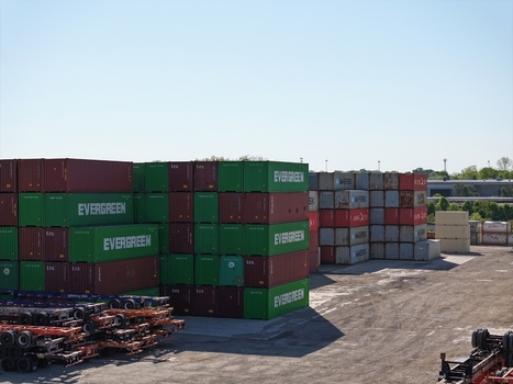 Cincinnati United States 19 April 2026 Aerial view of stacks of colorful shipping containers in an industrial freight terminal under a clear blue sky.