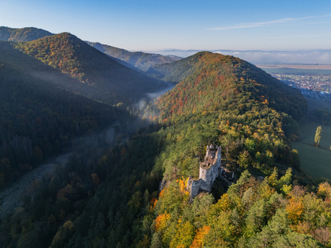 Aerial view of Blatnica castle ruins where stone walls meet the vibrant autumn forest under the vast blue sky Blatnica Zilinský kraj Slovakia. Aerial view of Blatnica castle ruins where stone walls meet the vibrant autumn forest under the vast blue sky Blatnica Zilinský kraj Slovakia.