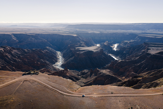 Aerial view of the rugged Fish River Canyon with its dramatic cliffs winding river and arid landscape stretching to the horizon Fish River Canyon Karas Region Namibia. Aerial view of the rugged Fish River Canyon with its dramatic cliffs winding river and arid landscape stretching to the horizon Fish River Canyon Karas Region Namibia.