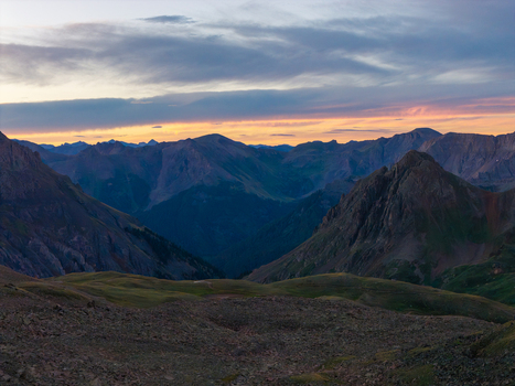 Aerial view of Mount Sneffels in the San Juan Mountain Range at sunset with rugged peaks rocky slopes and alpine terrain in the Yankee Boy Basin Ouray Colorado United States. Aerial view of Mount Sneffels in the San Juan Mountain Range at sunset with rugged peaks rocky slopes and alpine terrain in the Yankee Boy Basin Ouray Colorado United States.