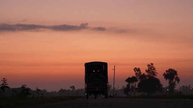 View of a truck silhouette on a rural road at sunset Bangladesh. View of a truck silhouette on a rural road at sunset Bangladesh.