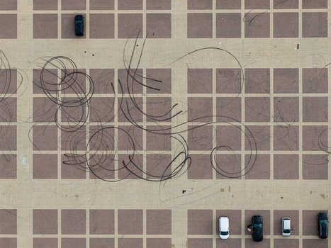 Aerial view of tire marks on the paved surface of the Olympiastadion Berlin parking area with parked cars in Berlin Berlin Germany.