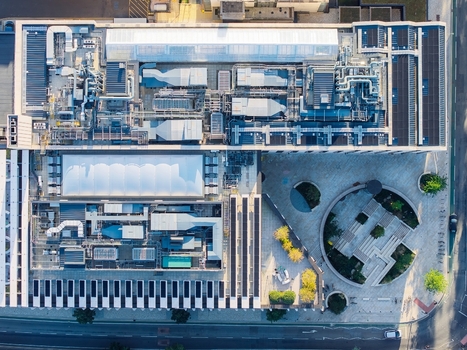 Aerial view of the Oxford data center featuring complex rooftop HVAC systems ventilation units and solar panels next to a circular courtyard in Oxford England United Kingdom.