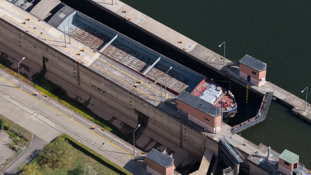 Aerial view of the Neckar Staustufe und Schleuse Rockenau with a cargo ship inside the lock chamber on the Neckar river in Eberbach Baden Wurttemberg Germany.
