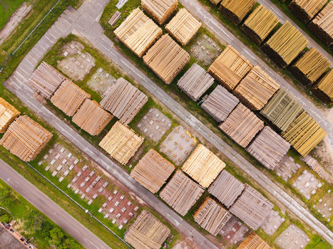 Aerial view of stacks of cut timber and logs arranged in neat rows at a lumber yard in Brankas Jelgava Municipality Latvia. Aerial view of stacks of cut timber and logs arranged in neat rows at a lumber yard in Brankas Jelgava Municipality Latvia.