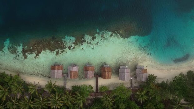 Aerial view of overwater bungalows in Raja Ampat Indonesia.