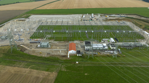 Aerial view of Umspannwerk Ottenhofen electrical substation with high voltage power lines and infrastructure surrounded by agricultural fields in Ottenhofen Bayern Germany.