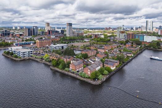 Aerial view of MediaCityUK and the surrounding residential buildings along the waterfront in Salford England United Kingdom. Aerial view of MediaCityUK and the surrounding residential buildings along the waterfront in Salford England United Kingdom.