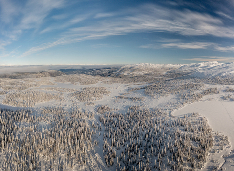 Aerial view of Gaustablikk Fjellresort surrounded by snow covered pine forests and frozen lakes under a clear blue sky in Rjukan Telemark Norway. Aerial view of Gaustablikk Fjellresort surrounded by snow covered pine forests and frozen lakes under a clear blue sky in Rjukan Telemark Norway.
