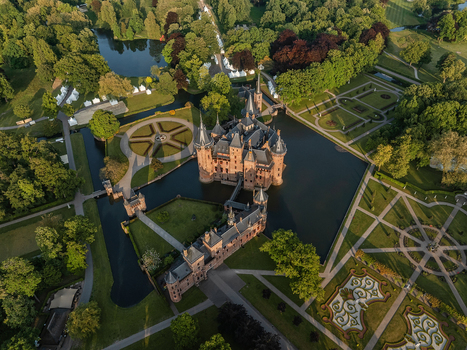 Aerial view of De Haar Castle featuring its Gothic style architecture surrounding moat and meticulously manicured formal gardens in Utrecht Utrecht Netherlands. Aerial view of De Haar Castle featuring its Gothic style architecture surrounding moat and meticulously manicured formal gardens in Utrecht Utrecht Netherlands.