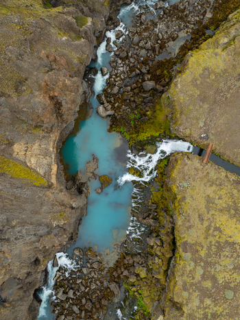 Aerial view of Sigoldugljufur canyon with its vibrant turquoise water rocky cliffs and mossy terrain in Rangarthing ytra Iceland. Aerial view of Sigoldugljufur canyon with its vibrant turquoise water rocky cliffs and mossy terrain in Rangarthing ytra Iceland.
