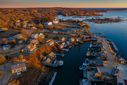 View of Martha s Vineyard featuring the historic fishing shacks and boats at sunset in Edgartown Massachusetts United States.