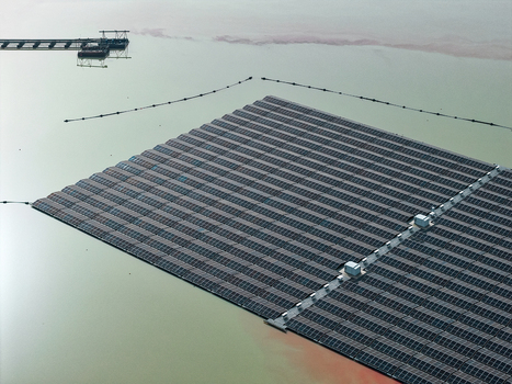 Aerial view of a large floating solar farm array on a calm lake surface in Dulmen North Rhine Westphalia Germany. Aerial view of a large floating solar farm array on a calm lake surface in Dulmen North Rhine Westphalia Germany.