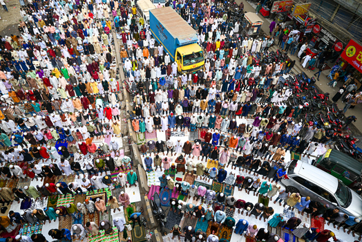 Tongi Bangladesh 31 January 2025 Aerial view of Tongi Ijtema Maidan with a massive crowd of worshippers gathered for prayer on colorful mats surrounded by vehicles.