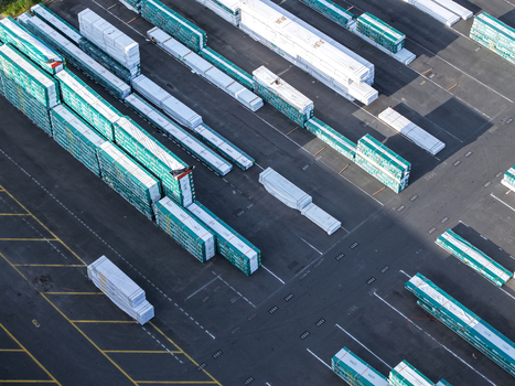 Melbourne VIC Australia 22 September 2026 Aerial view of an industrial storage yard in Kilsyth featuring rows of stacked white and green construction materials on asphalt pavement. Melbourne VIC Australia 22 September 2026 Aerial view of an industrial storage yard in Kilsyth featuring rows of stacked white and green construction materials on asphalt pavement.