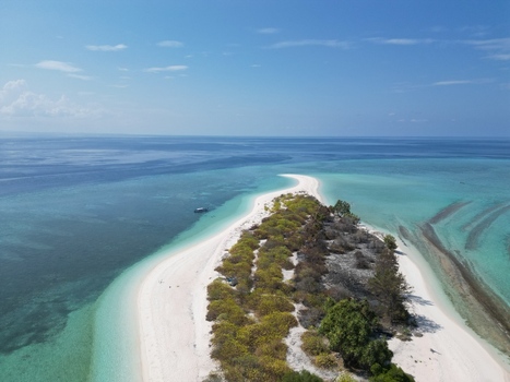 Aerial view of Pulau Ndaa a small tropical island with white sand beaches turquoise waters and lush vegetation in Tomia South East Sulawesi Indonesia.