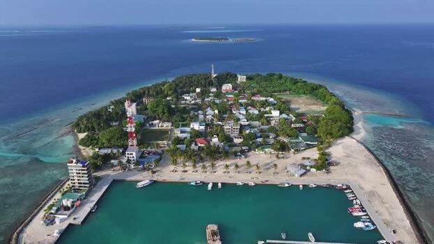 Aerial view of Kamadhoo island with its harbor and lush greenery Maldives. Aerial view of Kamadhoo island with its harbor and lush greenery Maldives.