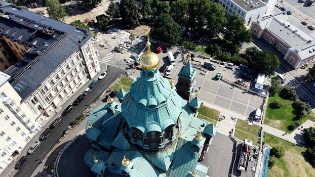 Aerial view of Uspenski Cathedral with its distinctive green copper domes and gold accents surrounded by historic buildings and urban streets in Helsinki Uusimaa Finland. Aerial view of Uspenski Cathedral with its distinctive green copper domes and gold accents surrounded by historic buildings and urban streets in Helsinki Uusimaa Finland.