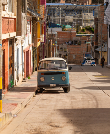 Puno Peru 23 June 2026 View of a vintage Volkswagen van parked on a quiet street with colorful buildings and overhead power lines in Puno.