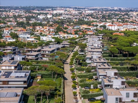 Aerial view of Quinta da Marinha residential area with modern houses pine trees and a road in Cascais Lisbon Portugal. Aerial view of Quinta da Marinha residential area with modern houses pine trees and a road in Cascais Lisbon Portugal.