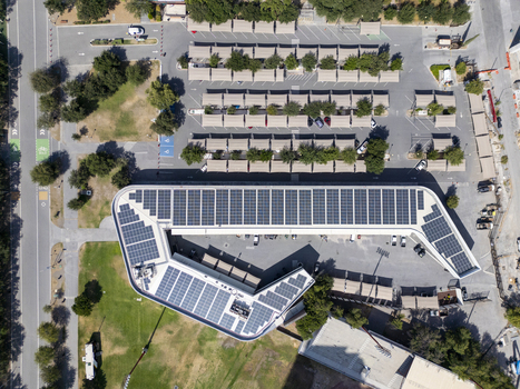 Aerial view of the solar panel covered roof of a building at Fundidora Park with adjacent parking areas and green spaces in Monterrey Nuevo Leon Mexico. Aerial view of the solar panel covered roof of a building at Fundidora Park with adjacent parking areas and green spaces in Monterrey Nuevo Leon Mexico.