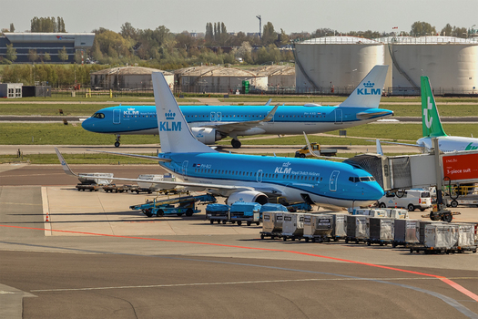Schiphol Netherlands 16 April 2026 View of KLM Royal Dutch Airlines airplanes parked at the terminal gates with ground service equipment and fuel tanks at Schiphol Airport. Schiphol Netherlands 16 April 2026 View of KLM Royal Dutch Airlines airplanes parked at the terminal gates with ground service equipment and fuel tanks at Schiphol Airport.