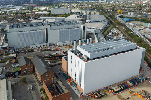 Aerial view of a large modern data center complex with industrial infrastructure and surrounding urban area United Kingdom. Aerial view of a large modern data center complex with industrial infrastructure and surrounding urban area United Kingdom.