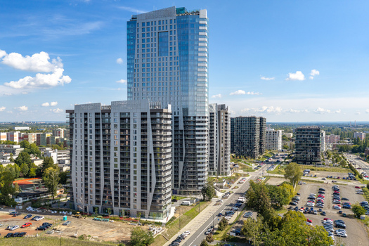 Aerial view of modern residential real estate featuring high rise apartment buildings with glass facades and balconies in Katowice Silesian Voivodeship Poland.