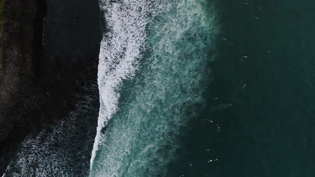 Aerial view of waves crashing on black sand beach New Zealand. Aerial view of waves crashing on black sand beach New Zealand.