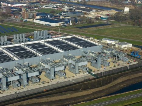 Aerial view of the Google data center featuring large industrial buildings cooling systems and solar panels in Winschoten Groningen Netherlands.