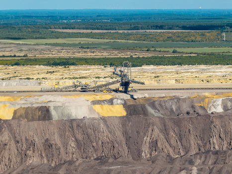 Aerial view of the Tagebau Welzow Sud brown coal open pit mine with a large bucket wheel excavator operating in the vast industrial landscape of Spremberg Brandenburg Germany. Aerial view of the Tagebau Welzow Sud brown coal open pit mine with a large bucket wheel excavator operating in the vast industrial landscape of Spremberg Brandenburg Germany.