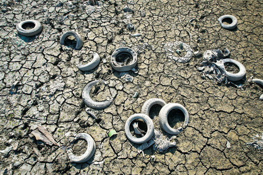 Aerial view of discarded old tires scattered across parched and cracked dry earth during a severe drought Carignano Piemonte Italy. Aerial view of discarded old tires scattered across parched and cracked dry earth during a severe drought Carignano Piemonte Italy.
