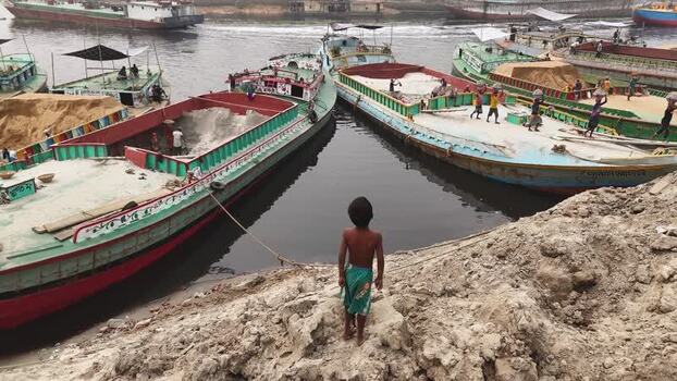 Aerial view of cargo boats and workers on a river in Bangladesh. Aerial view of cargo boats and workers on a river in Bangladesh.