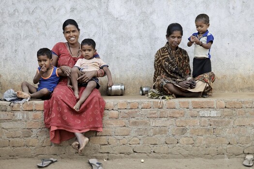 Odisha India 26 March 2026 View of a mother and children in Odisha India their vibrant clothing contrasting with the muted tones of the brick and plaster wall. Odisha India 26 March 2026 View of a mother and children in Odisha India their vibrant clothing contrasting with the muted tones of the brick and plaster wall.