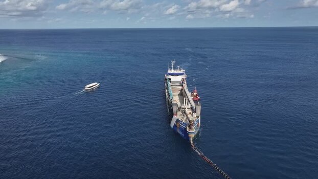Aerial view of a large industrial dredger in the ocean Maldives.