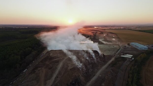 Aerial view of landfill smoke at sunset in Sremska Mitrovica Serbia.