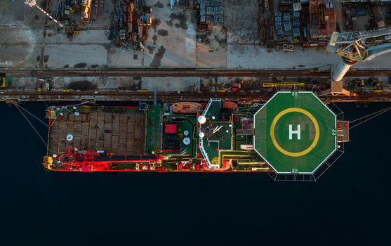 Aerial view of a ship with a prominent helipad docked at the industrial Uljanik Shipyard in Pula Croatia. Aerial view of a ship with a prominent helipad docked at the industrial Uljanik Shipyard in Pula Croatia.