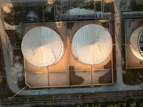 Aerial view of large industrial storage tanks and complex piping systems at a refinery in Augusta Sicily Italy. Aerial view of large industrial storage tanks and complex piping systems at a refinery in Augusta Sicily Italy.