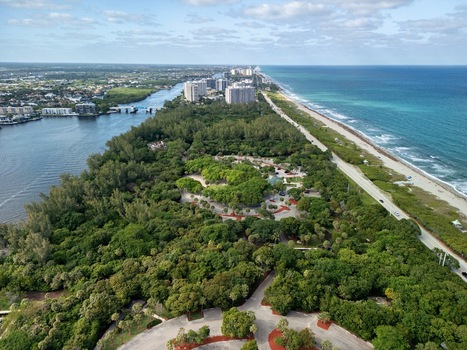 Aerial view of lush coastal parkland between the Atlantic Ocean and Intracoastal Waterway with high rise buildings in the distance Boca Raton Florida United States. Aerial view of lush coastal parkland between the Atlantic Ocean and Intracoastal Waterway with high rise buildings in the distance Boca Raton Florida United States.