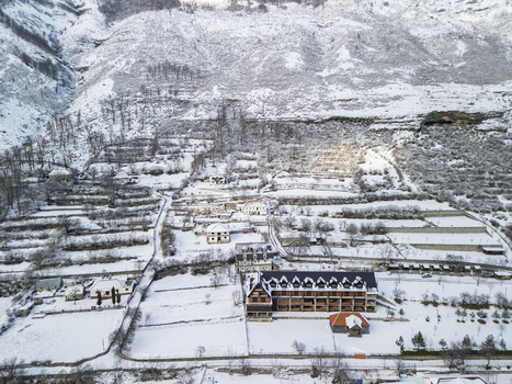 Aerial view of Camping Albania Boga Alpine Guest House nestled in the snow covered terraced slopes of the Albanian Alps in Boge Shkoder County Albania.