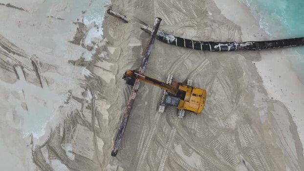 Aerial view of an excavator working on a beach Maldives.