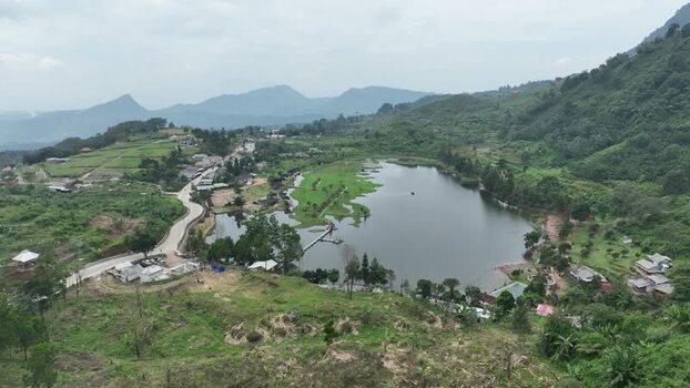 Aerial view of Rawa Gede Jonggol Lake and green hills Indonesia.