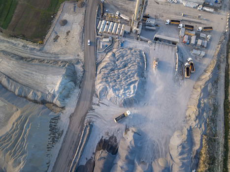 Aerial view of an industrial quarry site with piles of gravel heavy machinery and trucks parked on a dusty ground in Istanbul Istanbul Turkiye.