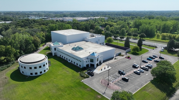 Aerial view of the pristine white building complex with a round structure and parking lot nestled amidst a vibrant green landscape Plymouth Minnesota United States.