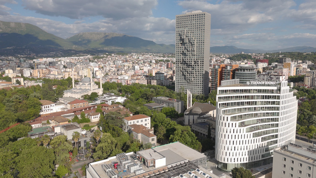 Aerial view of the Tirana skyline featuring the TID Tower and Tirana Bank building surrounded by urban architecture and distant mountains in Tirane Tirana County Albania.