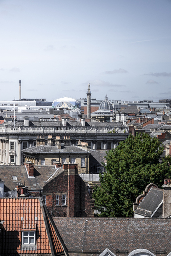Aerial view of Grey s Monument rising above the historic stone rooftops and urban skyline of Newcastle upon Tyne England United Kingdom. Aerial view of Grey s Monument rising above the historic stone rooftops and urban skyline of Newcastle upon Tyne England United Kingdom.