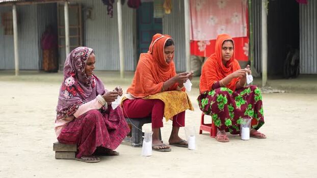 View of women making handicrafts outdoors Bangladesh. View of women making handicrafts outdoors Bangladesh.