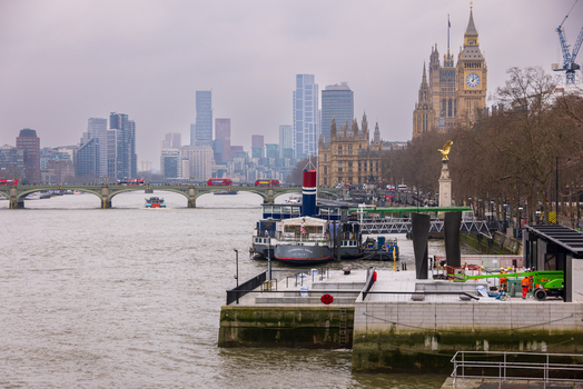 London United Kingdom 12 May 2025 View of the Palace of Westminster and Big Ben overlooking the River Thames with Westminster Bridge and the city skyline under a cloudy sky.