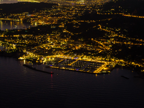 Aerial view of the coastal village of Eze illuminated at night with its marina and harbor lights reflecting on the Mediterranean Sea in Eze Provence Alpes Cote d Azur France. Aerial view of the coastal village of Eze illuminated at night with its marina and harbor lights reflecting on the Mediterranean Sea in Eze Provence Alpes Cote d Azur France.
